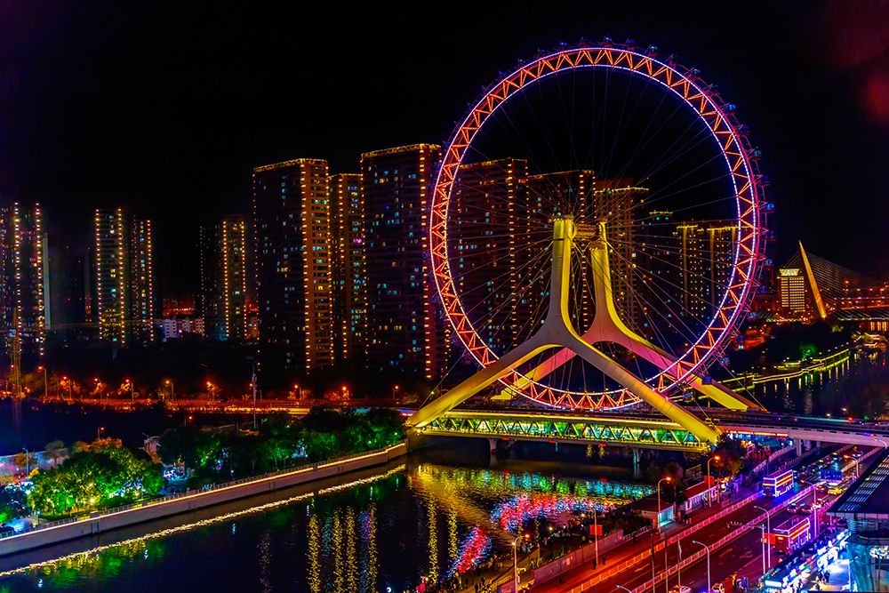 Colorful large ferris wheel over Yongle Bridge, Tianjin, China. Built in 2007.